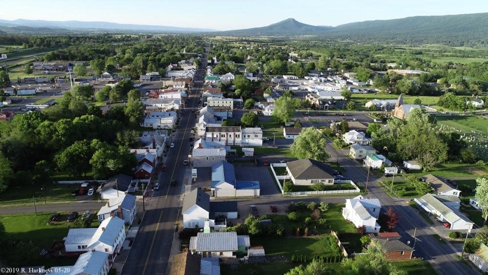 Aerial photograph of New Market’s streets and buildings with the Shenandoah Valley mountains beyond
